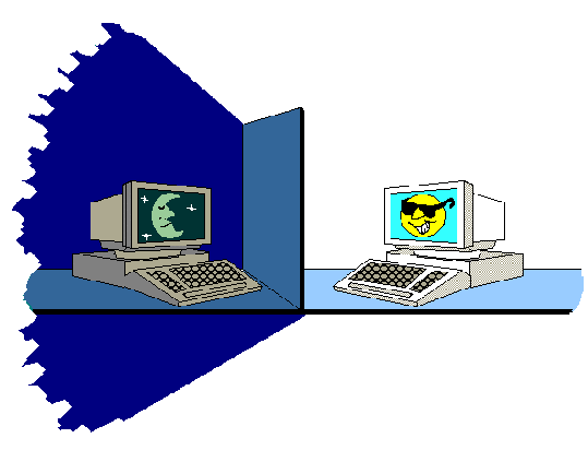 Two computers with a cubicle wall between them. One has a dark screen and sits in shadow. The other has a bright screen and sits in light.